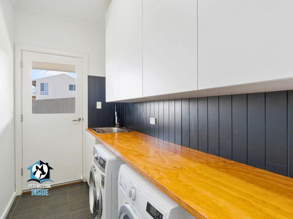 a kitchen with white cabinets and a wooden counter top at Ultimate in Middleton Coastal Style with Views Sleeps 10 in Middleton