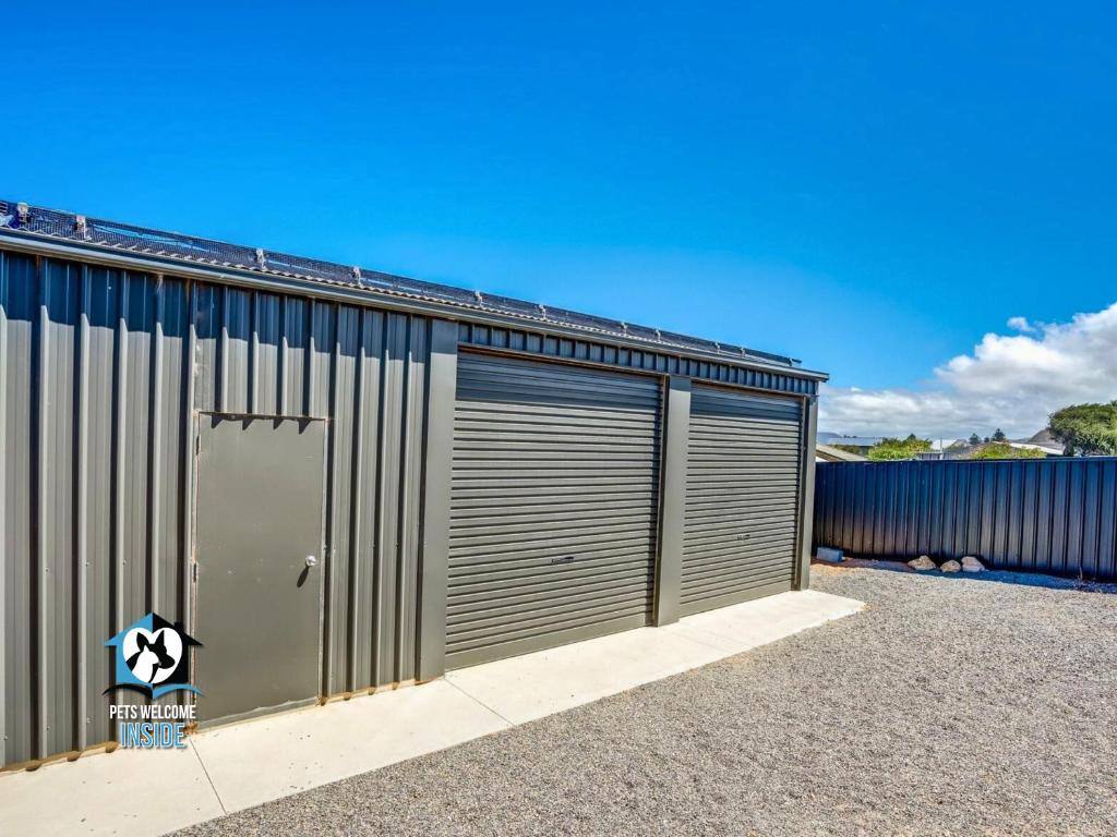 a metal building with two garage doors on it at Ultimate in Middleton Coastal Style with Views Sleeps 10 in Middleton