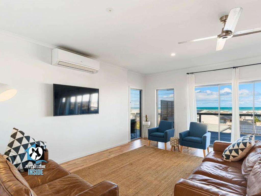 a living room with a couch and chairs and windows at Ultimate in Middleton Coastal Style with Views Sleeps 10 in Middleton
