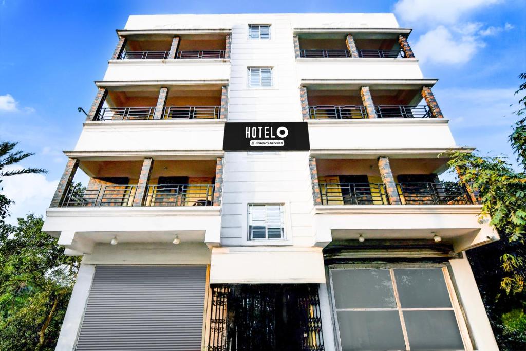 a white building with a black sign on it at Super Hotel O Ecopark Kolkata in kolkata