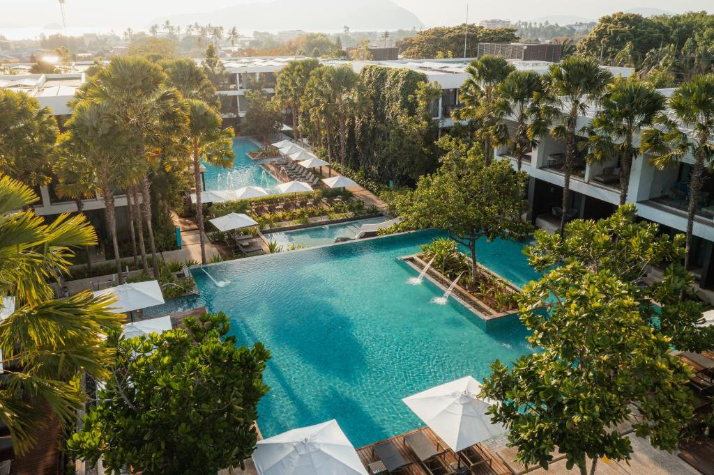 an overhead view of a large pool with trees and buildings at Stay Wellbeing & Lifestyle Resort in Rawai Beach