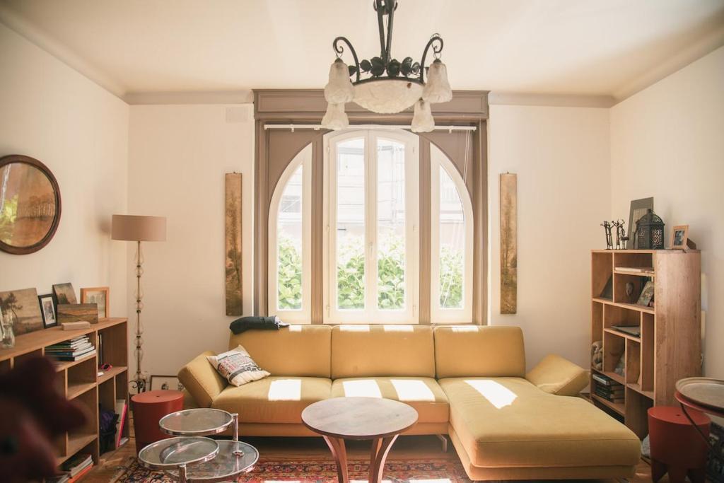 un salon avec un canapé et une grande fenêtre dans l'établissement Les Hortensias, maison de ville, à Capbreton