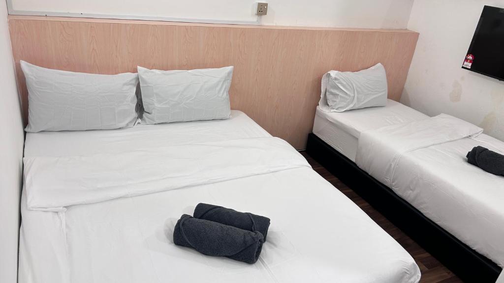 Postel nebo postele na pokoji v ubytování NEW Xing Yue Hotel 星悦自助酒店