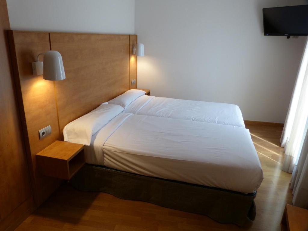 Postel nebo postele na pokoji v ubytování Hotel Avenida