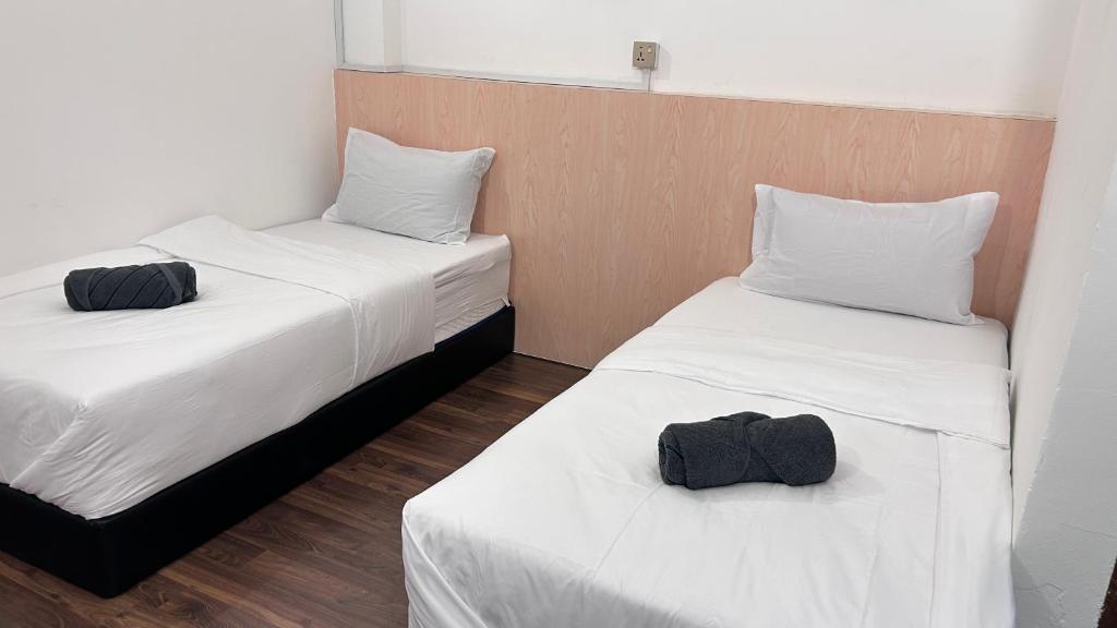 Postel nebo postele na pokoji v ubytování NEW Xing Yue Hotel 星悦自助酒店
