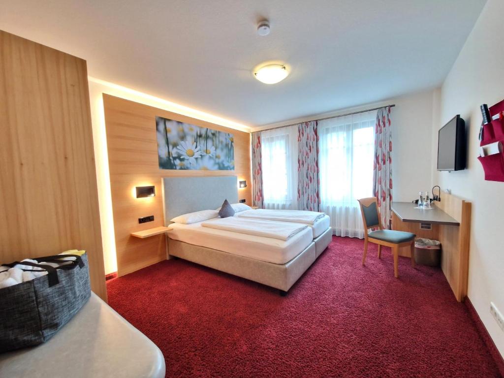 Postel nebo postele na pokoji v ubytování Mosers Blume Relax & Genuss Hotel