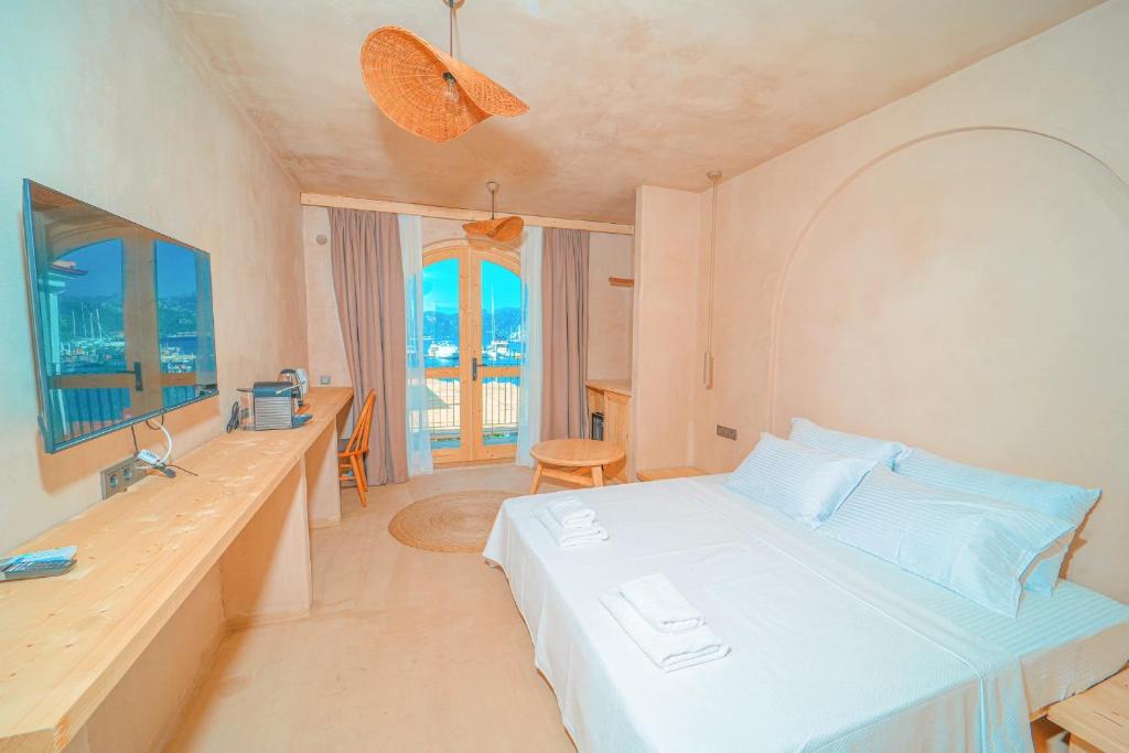 a bedroom with a bed and a desk and a window at Felix Rooms in Marmaris