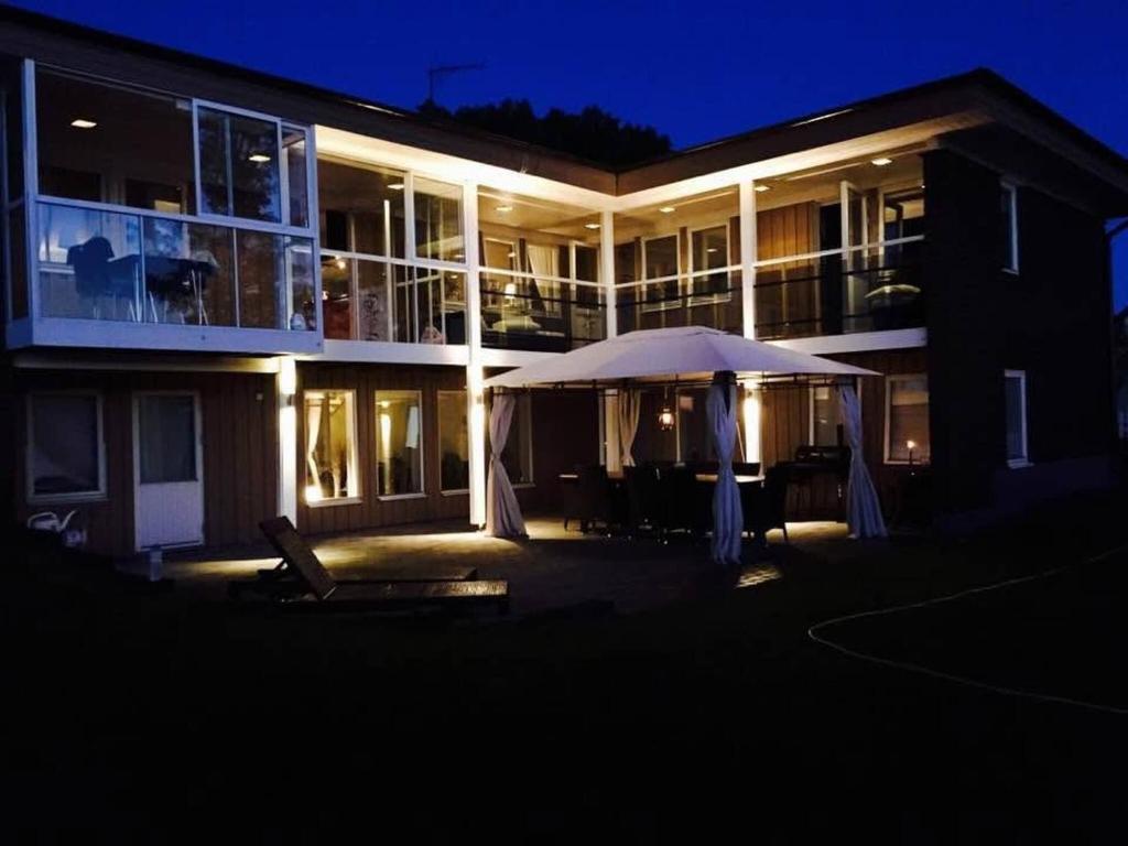 a large building with an umbrella in front of it at night at Ronneby Torneryd Retreat in Ronneby
