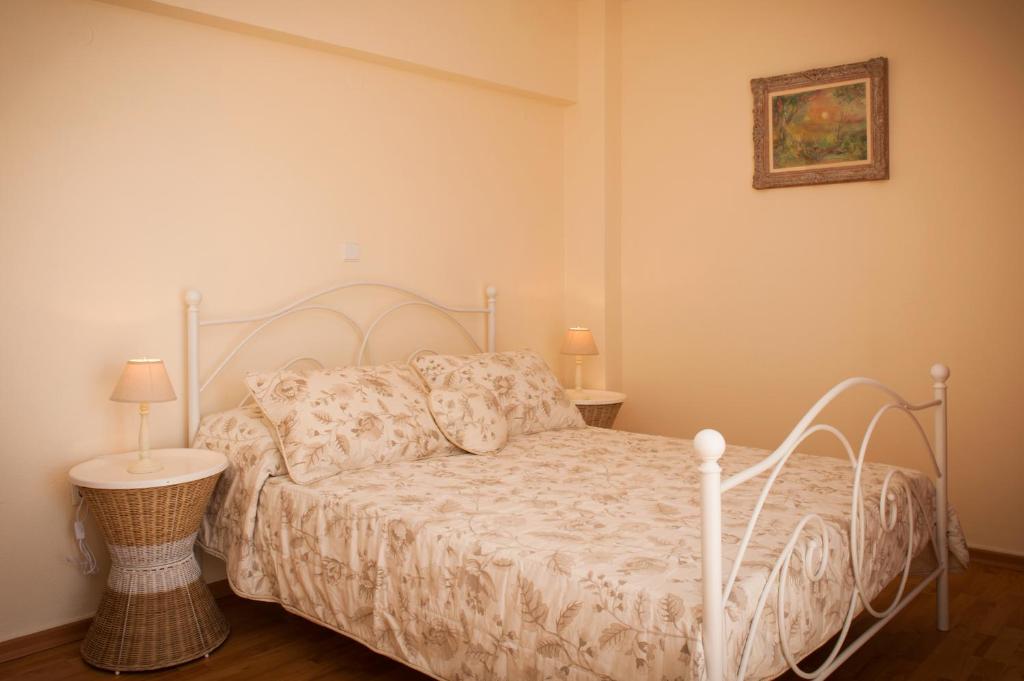 a bedroom with a bed with a white bedspread at Port House in Rhodes Town