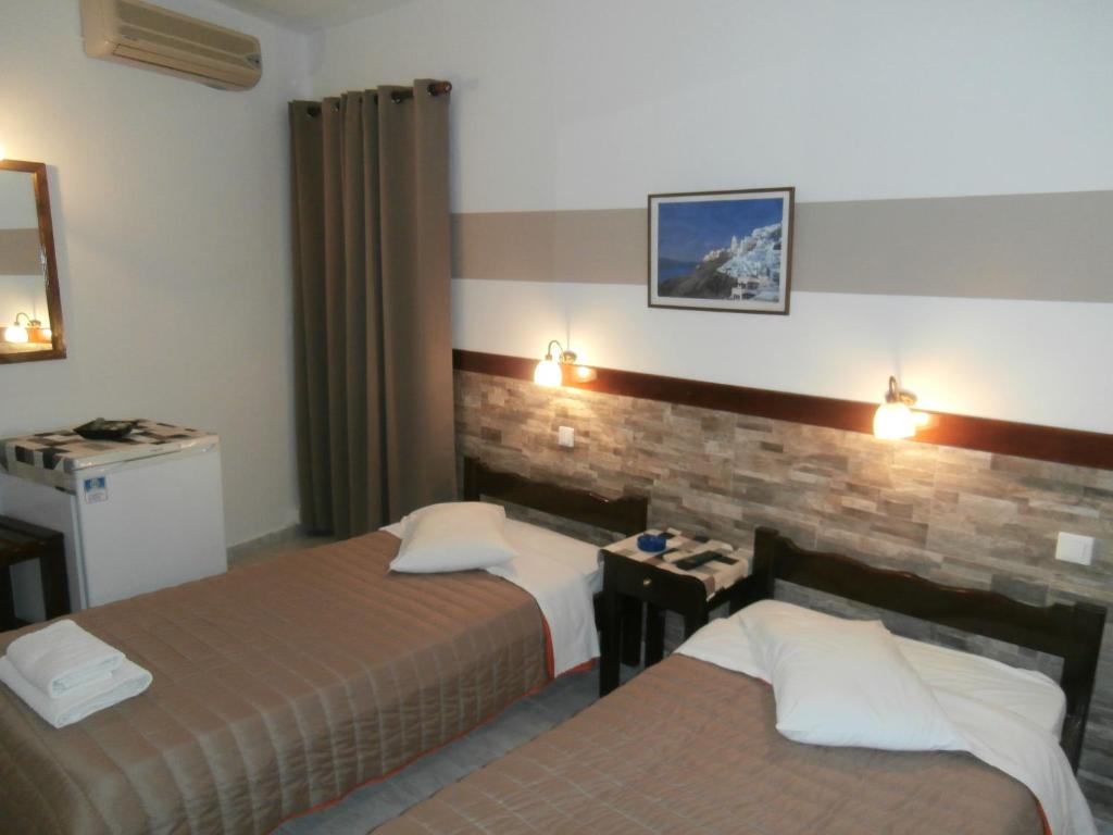 Ένα ή περισσότερα κρεβάτια σε δωμάτιο στο Ξενοδοχείο Νάρκισσος
