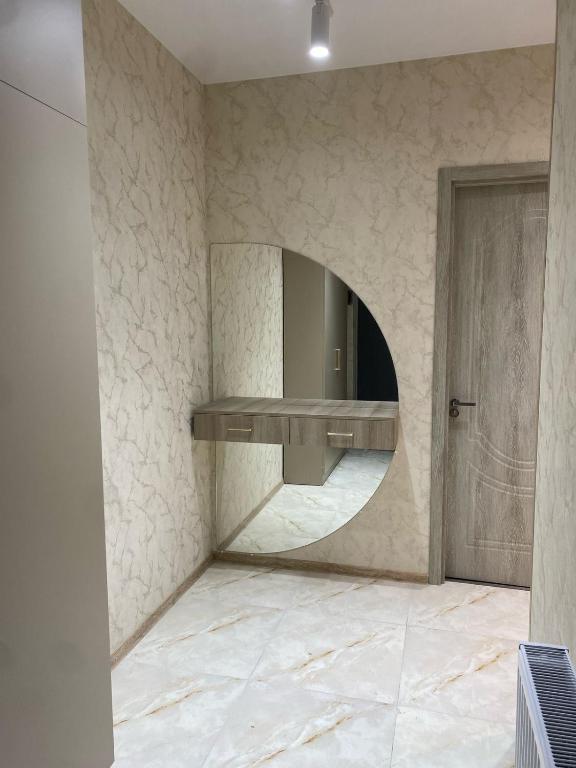 a bathroom with a mirror and a marble floor at Nadikvari in Tbilisi City