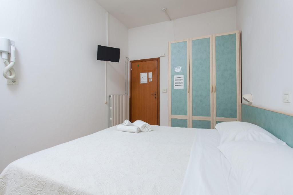 Postel nebo postele na pokoji v ubytování Hotel Luca