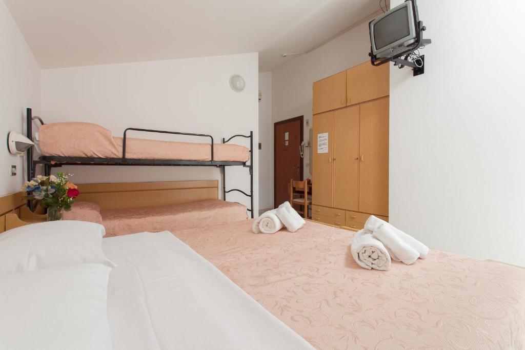 Postel nebo postele na pokoji v ubytování Hotel Luca