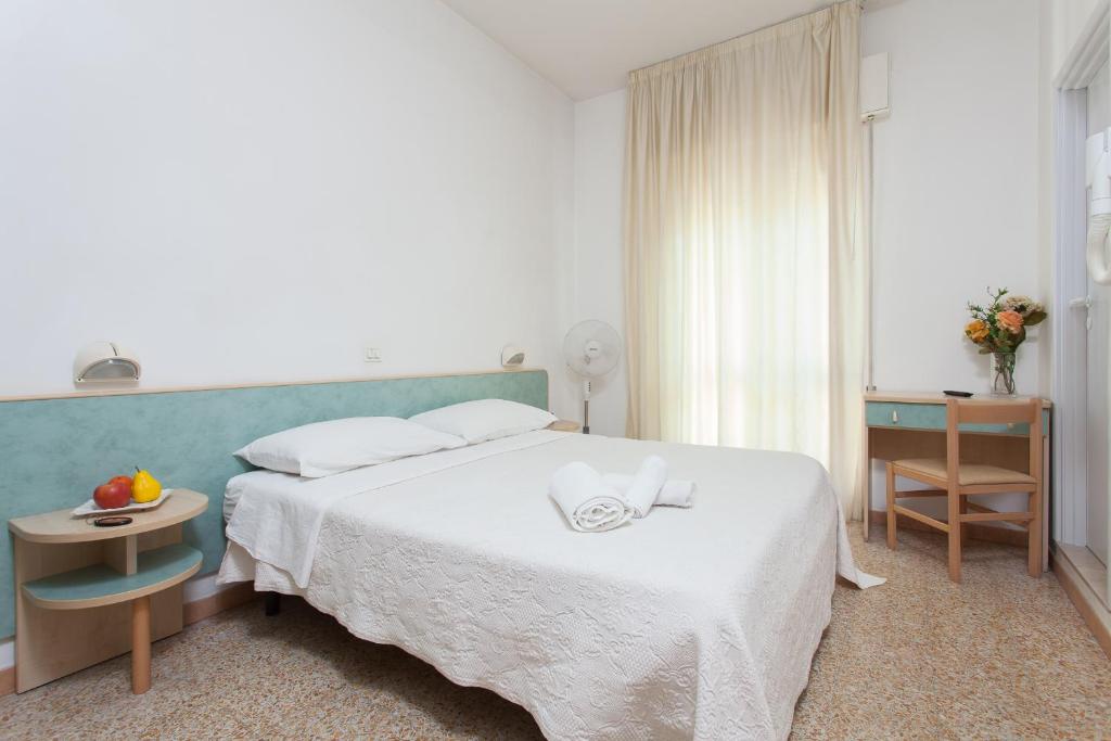 Postel nebo postele na pokoji v ubytování Hotel Luca