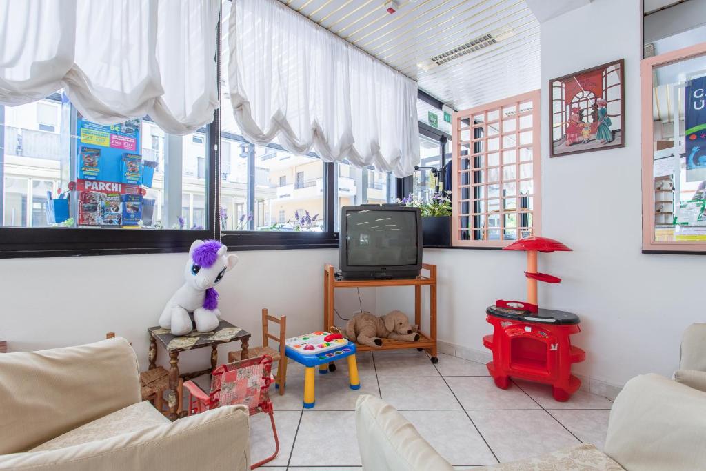 TV a/nebo společenská místnost v ubytování Hotel Luca