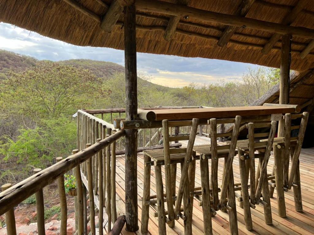 a wooden deck with chairs on top of a roof at Kolobeng Cottages in Gaborone