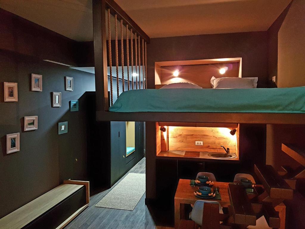 a room with a bunk bed with a fireplace at Apartments No.900001 in Mamaia