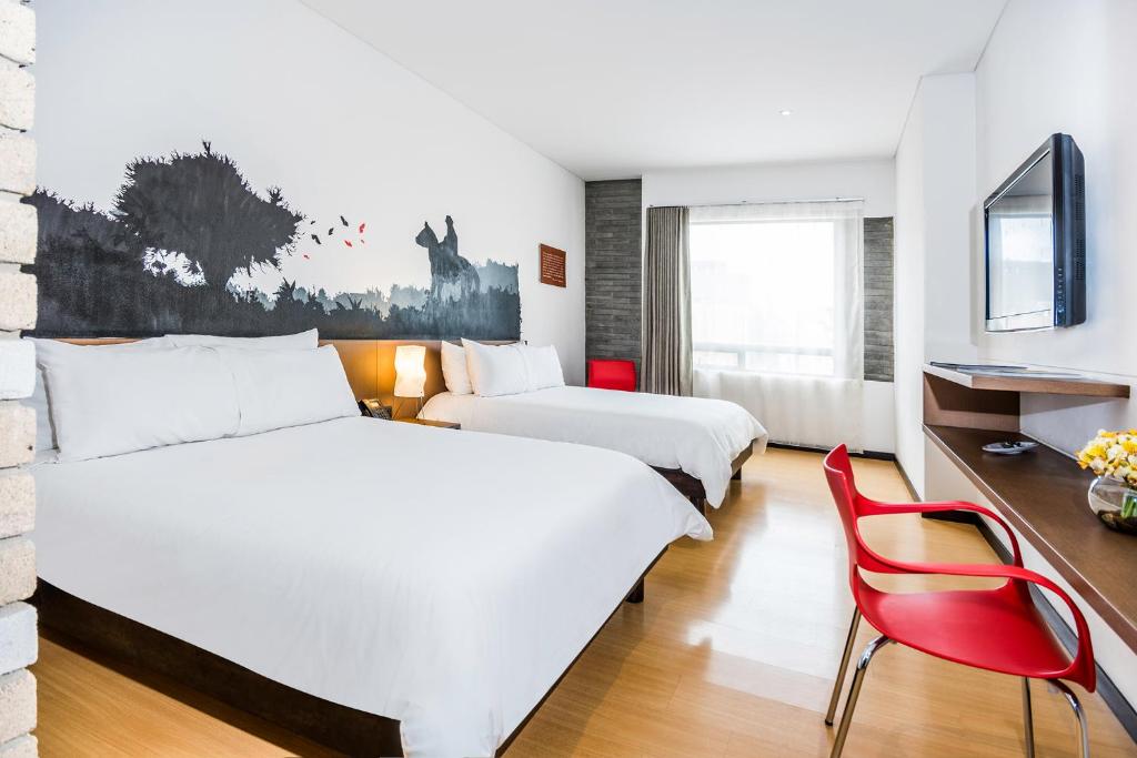 Un pat sau paturi într-o cameră la Hotel Viaggio Nueve Trez