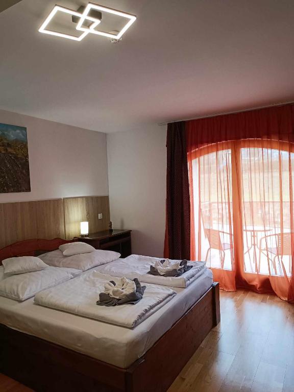 Postel nebo postele na pokoji v ubytování Margaréta Apartman és Üdülőház