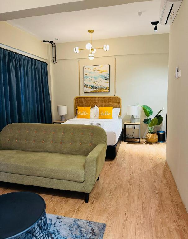 A bedroom photographed from the seating area, with a sofa facing the bed.