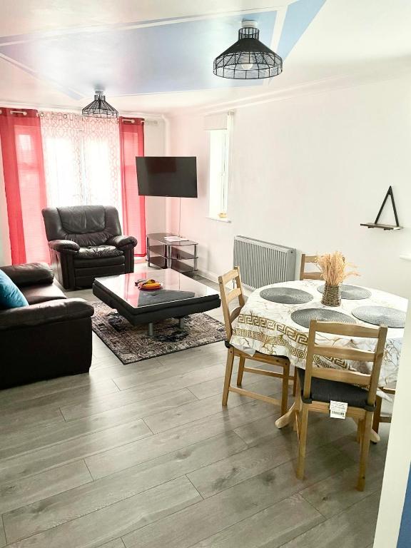 a living room with a table and a couch at The Grand Forsyth Apartment - Two bedroom in Dagenham