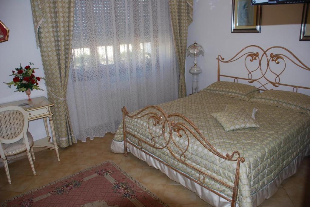 Postel nebo postele na pokoji v ubytování B&B La Rosa Antica