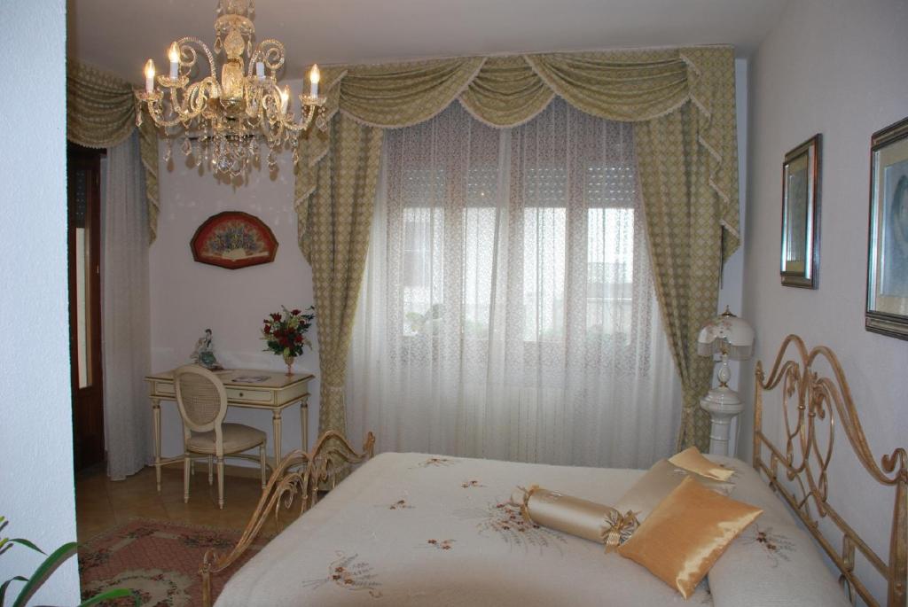 Postel nebo postele na pokoji v ubytování B&B La Rosa Antica