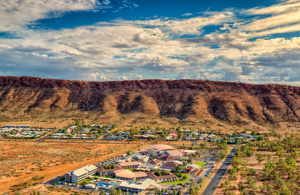 an aerial view of a village in front of a mountain at Crowne Plaza Alice Springs Lasseters by IHG in Alice Springs