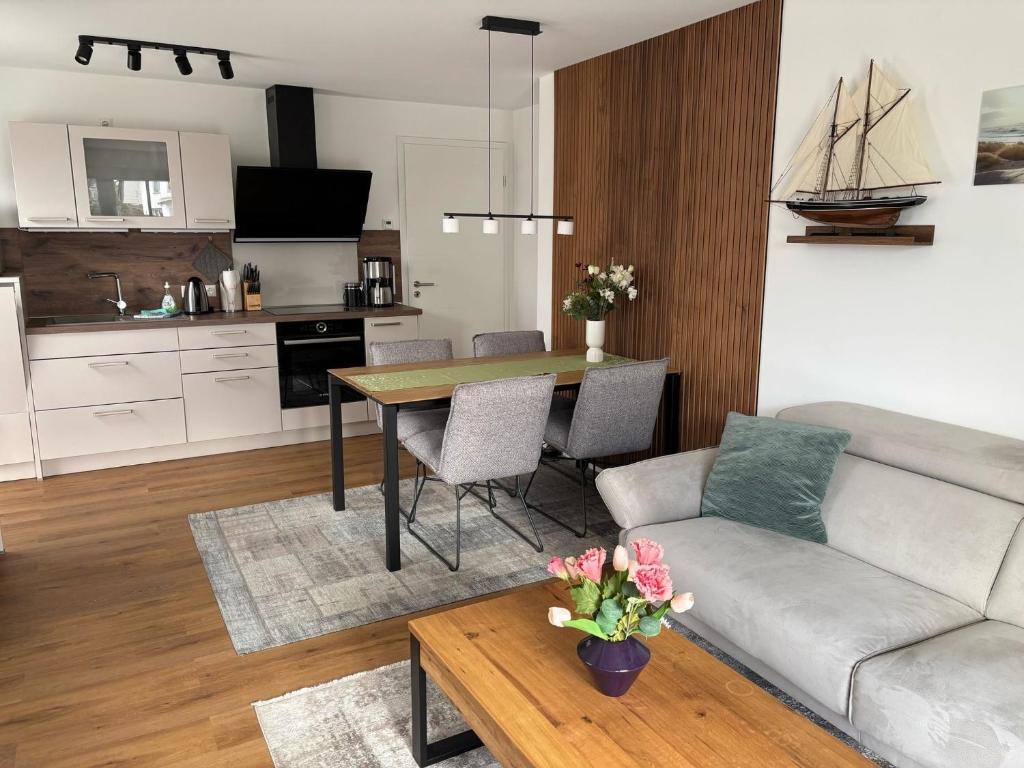 a living room with a couch and a table at Ostseemöwe NEU in Zingst