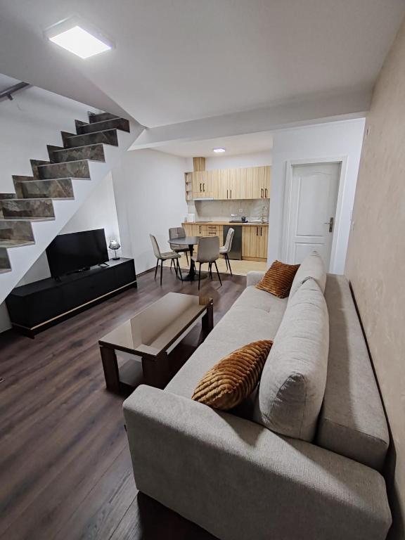 a living room with a couch and a staircase at Villa Jelena in Banja Koviljača
