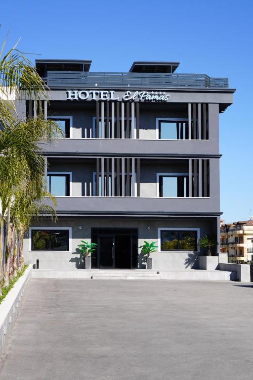 a large white building with a sign on it at Hotel El Pamas in Mugnano di Napoli