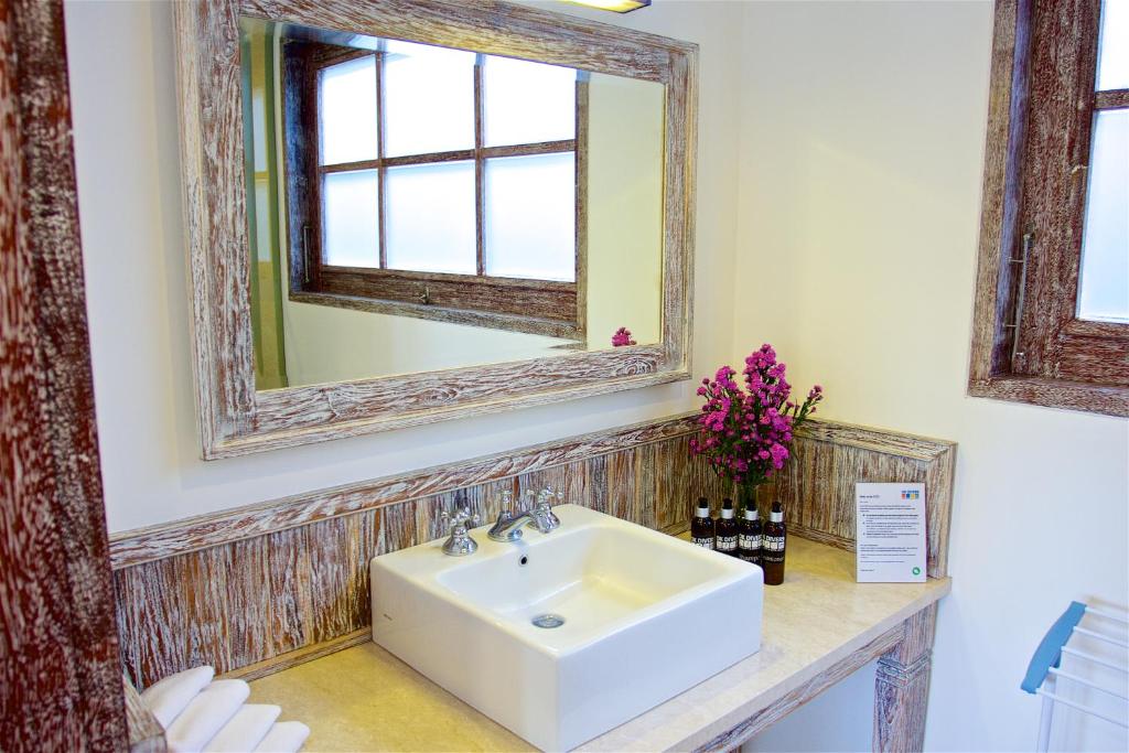 a bathroom with a sink and a mirror at OK Divers Resort & Spa in Padangbai