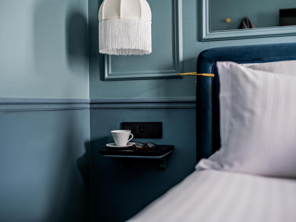 Postel nebo postele na pokoji v ubytování Hotel Duquesne Eiffel