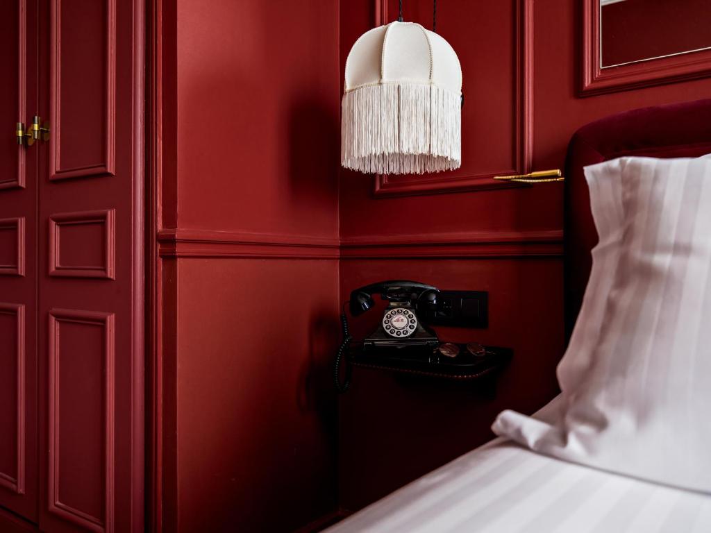 Postel nebo postele na pokoji v ubytování Hotel Duquesne Eiffel
