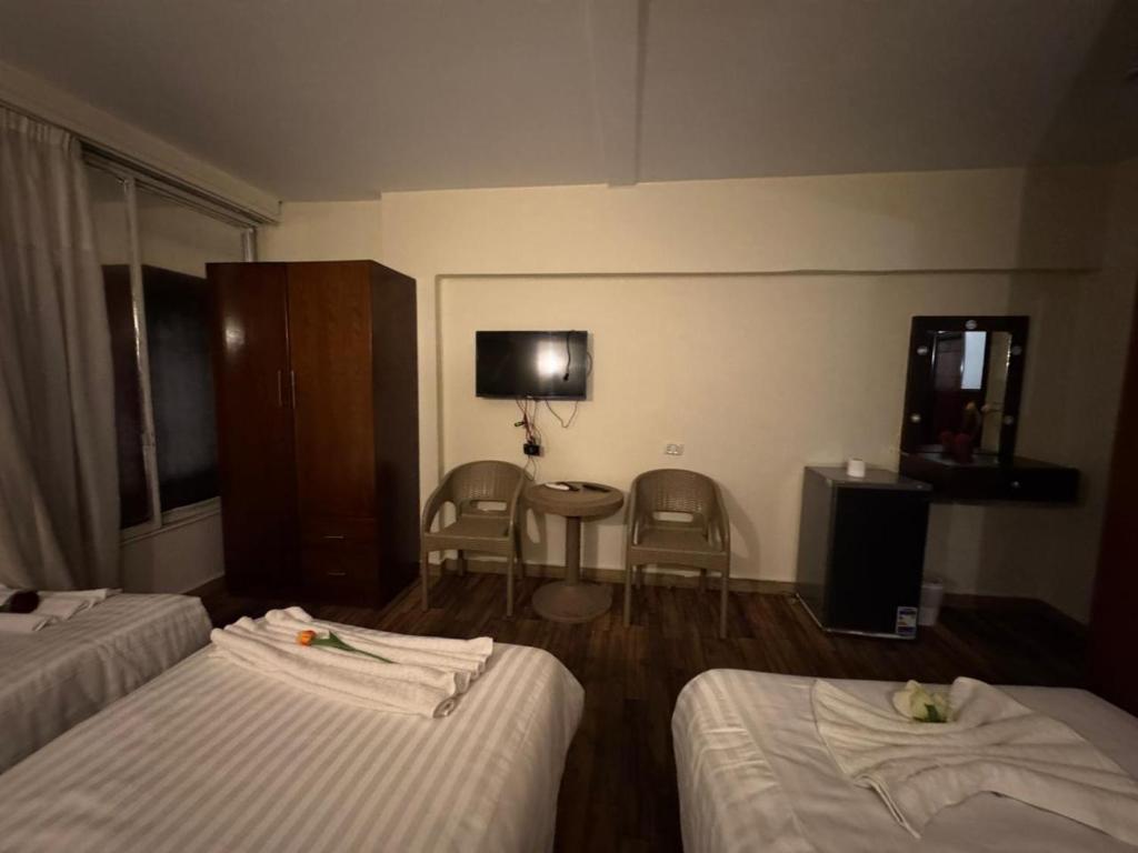 Postel nebo postele na pokoji v ubytování Lorenda palace hotel