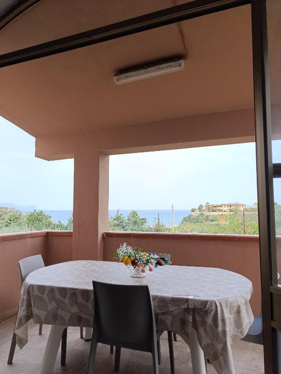 a dining room with a table and chairs and a window at Villa Giardini in Balestrate