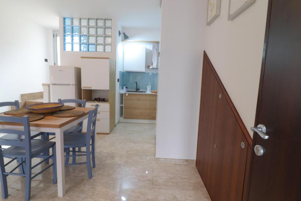 a kitchen and dining room with a table and chairs at Casa Malika a Otranto in Otranto