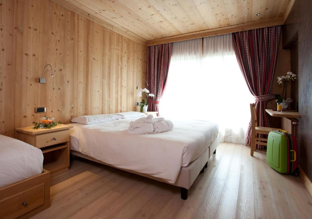 Postel nebo postele na pokoji v ubytování Hotel Funivia