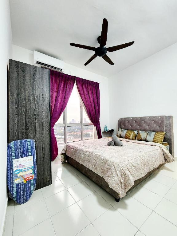 a bedroom with a bed and a ceiling fan at 3km to Malacca town by Define Suite in Malacca