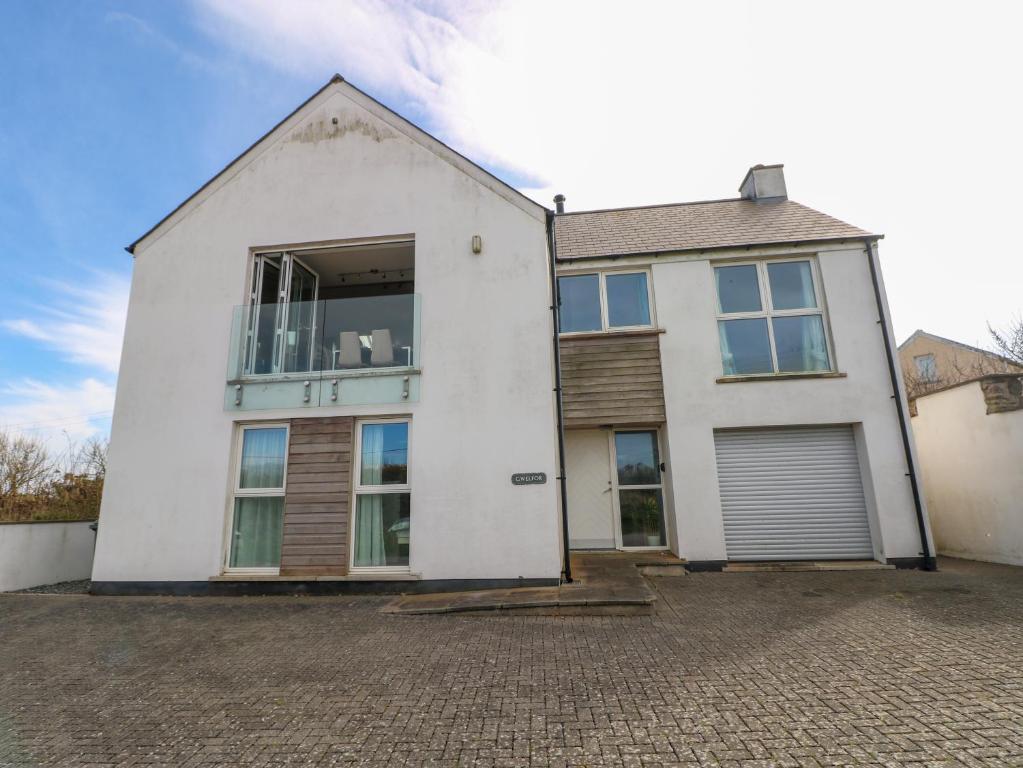 a white house with a lot of windows at Gwelfor, Marloes in Haverfordwest