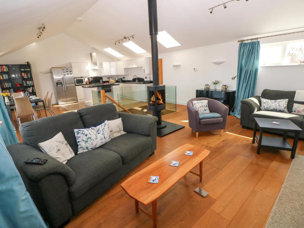 a living room with a couch and a fireplace at Gwelfor, Marloes in Haverfordwest