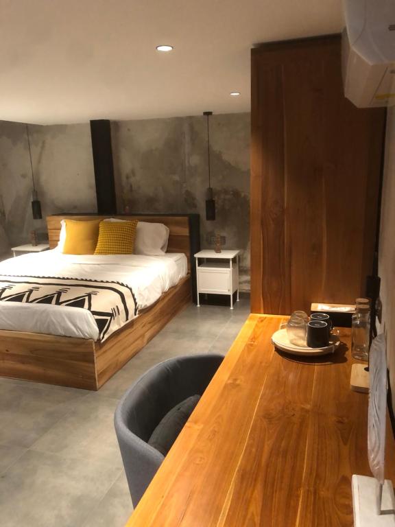 a bedroom with a bed and a wooden table at Flex Living Canggu in Canggu
