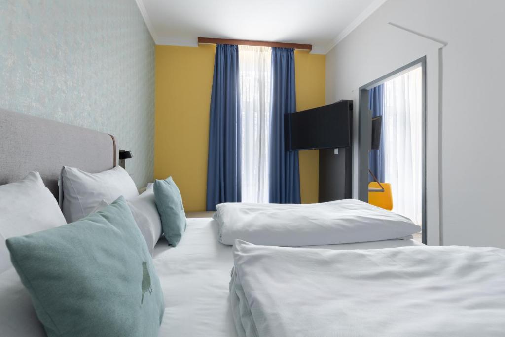 Postel nebo postele na pokoji v ubytování Garner Hotel Vienna by IHG