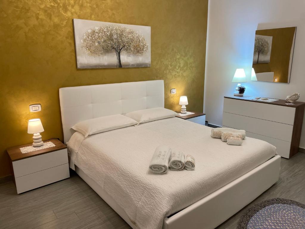 a bedroom with a bed with two pairs of shoes on it at La Rosa Blu in San Vito lo Capo