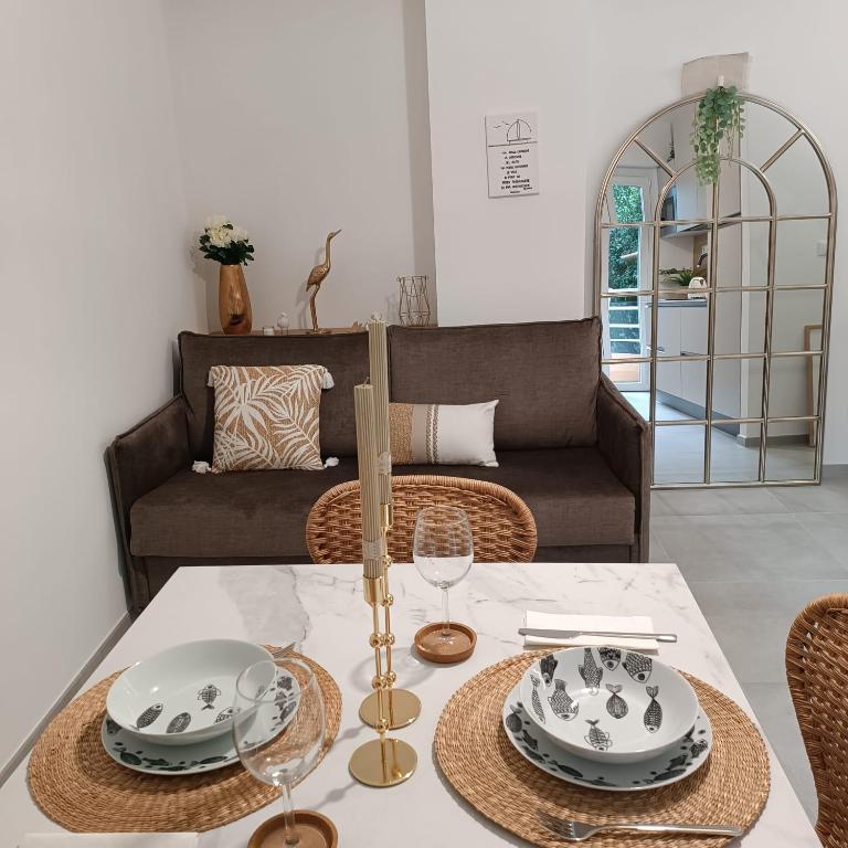 a dining room with a table and a couch at Onda d'Oro in Finale Ligure