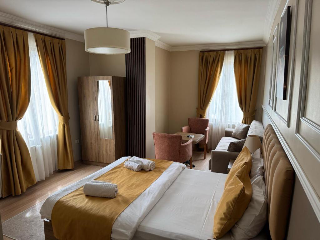 a hotel room with a bed and a couch at NEW BEYLERBEYİ HOTEL in Istanbul