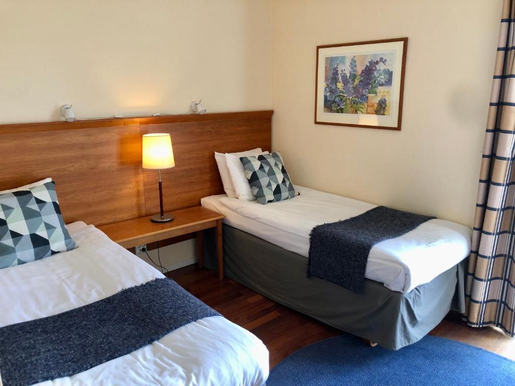 Postel nebo postele na pokoji v ubytování Vätterleden Hotell & Restaurang