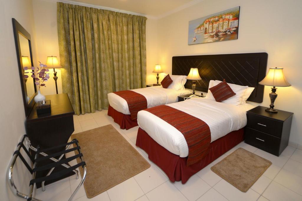 Postel nebo postele na pokoji v ubytování Alain Hotel Ajman