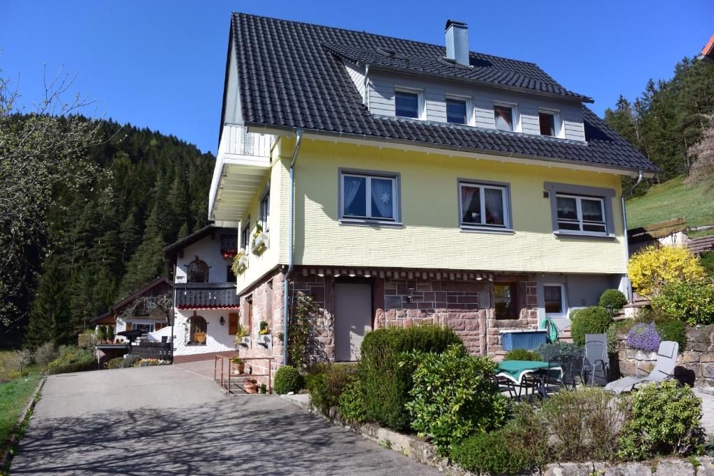 a yellow house with a black roof at Ferienhaus Günter in Baiersbronn