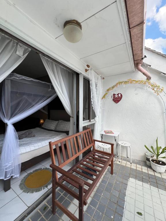 a room with a bed and a bench on a balcony at The Studio Apartment at Selesa Hillhomes Bukit Tinggi Bentong in Bentong